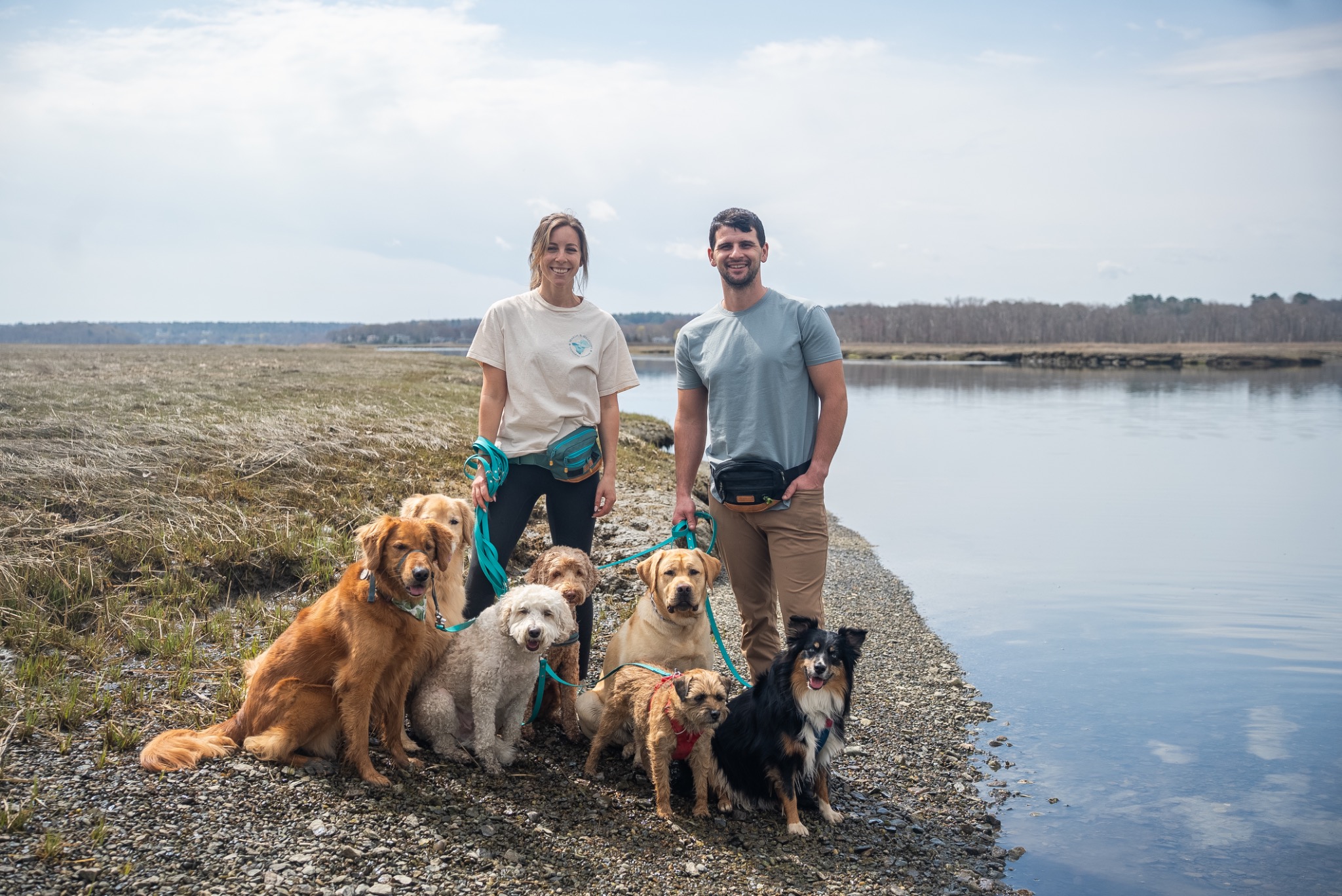 Anna and Jake surrounded by the pack near the water